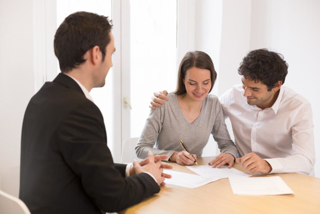 a couple signing a contract